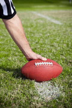 Referee: Holding Football on Field