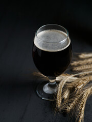 Dark beer glass on black table