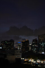 Obraz premium Night Cityscape Under a Dark Cloudy Sky