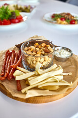 Charcuterie Board with Cheese, Nuts, and Sausages