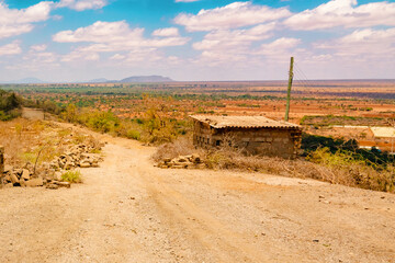 Scenic view of an empty dirt road in the panoramic arid landscapes of Voi Town in Kenya 