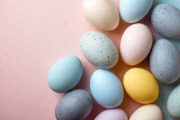 A topdown view of pastelcolored speckled eggs on a light pink surface