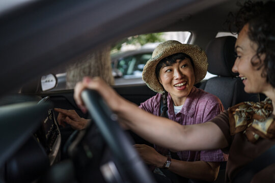 female friends go together on road trip have fun while driving in a car - Powered by Adobe