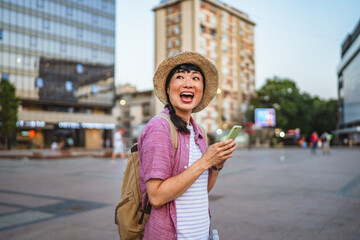 japanese woman use mobile phone walk with suitcase and touring city