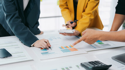 Adult Asian Business Team Analyzes Financial Charts Graphs Reports on White Table for Strategic Planning Accounting and Investment