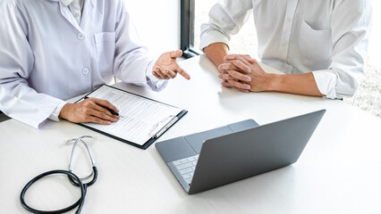 Doctor consulting patient discussing something symptom of disease and recommend treatment methods,...