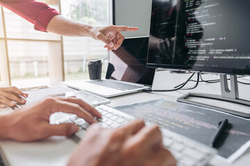 Two professional programmer cooperating and working on web site project in a software developing on...