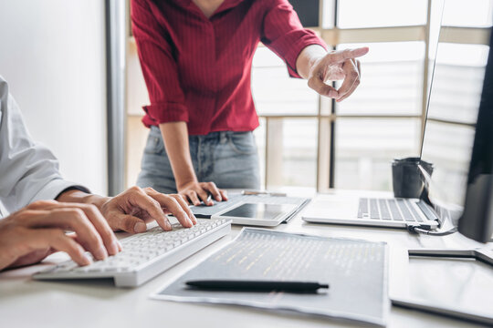 Programmers cooperating at Developing programming and website working in a software develop company office, writing codes and typing data code, Programming with HTML, PHP and javascript