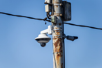 Surveillance cctv security camera. Utility pole with power cables and communication box. urban area...