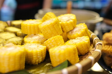 Cooked corn on the cob plated and on a wooden table. High quality photo