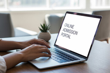 Person typing on laptop with online admission portal displayed hands screen
