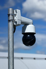 Outdoor dome surveillance camera mounted on metal pole