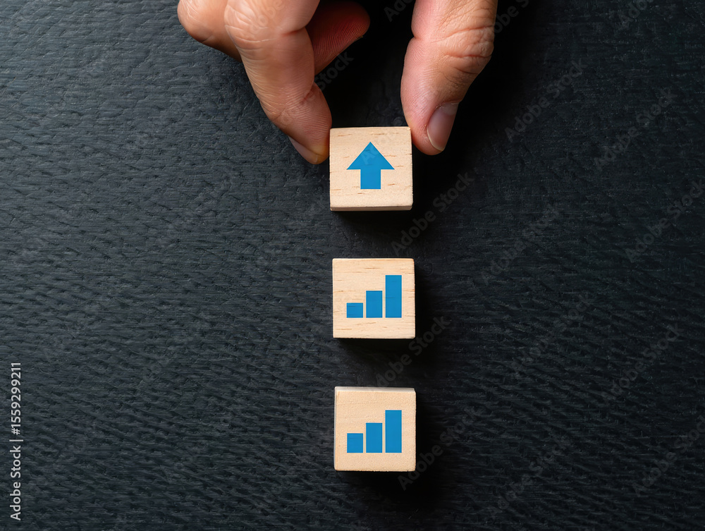 Aufkleber elevate your business strategy a hand placing a wooden block with an upward arrow on top of a stack 