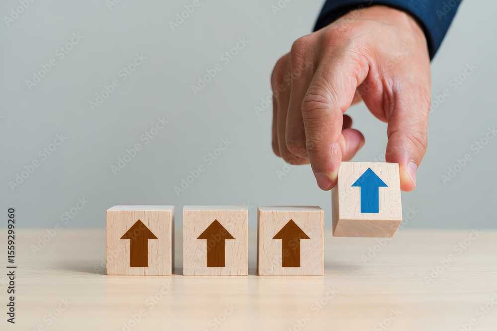 Poster building business success a hand placing a final block with an upward arrow on a row of blocks symbo