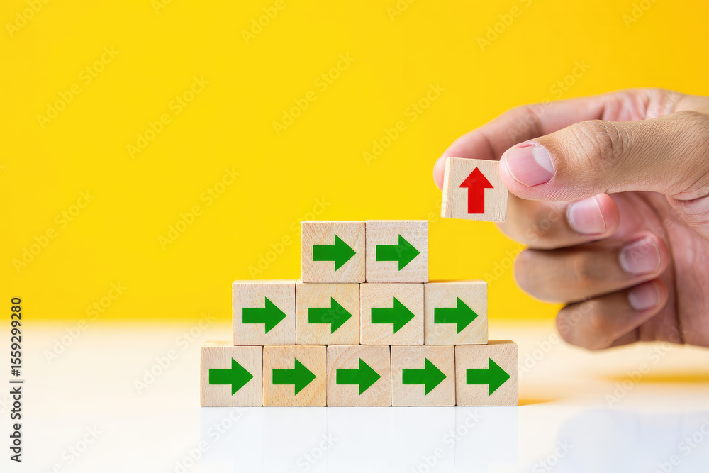 Poster strategic direction and goal achievement a hand placing a red arrow block on top of green arrow bloc