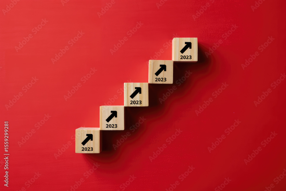 Poster year 2023 growth and progress concept wooden blocks stacked upward on a red background symbolizing b