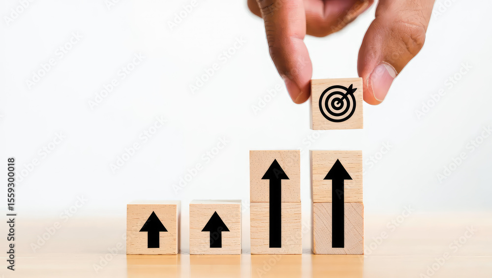 Poster achieving goals and growth a hand placing a target block on top of rising arrow blocks representing 