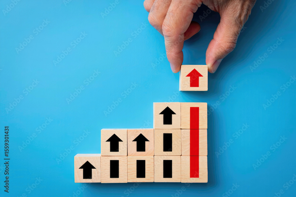 Aufkleber building success a hand places a red arrow block atop a stack of upward-pointing blocks symbolizing 