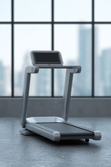 A treadmill is positioned in front of large windows in a modern interior setting. Fitness equipment indoors
