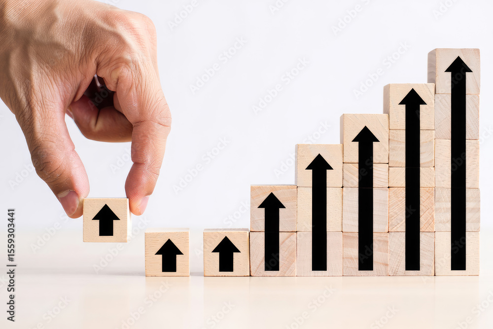 Aufkleber stepping up a hand adds an arrow block to a rising bar graph of wooden blocks with upward arrows rep