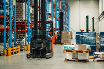 Forklift operator moving goods in modern warehouse logistics center