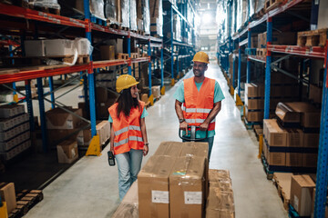 Warehouse workers transporting goods on pallet jack