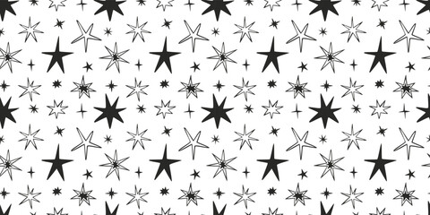 Seamless pattern with black hand-drawn stars on white background. Trendy design for festive, magical and celestial decor. Abstract modern vector illustration