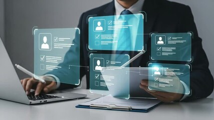 Man in suit using laptop and tablet with digital profile interfaces for recruitment process view - Powered by Adobe