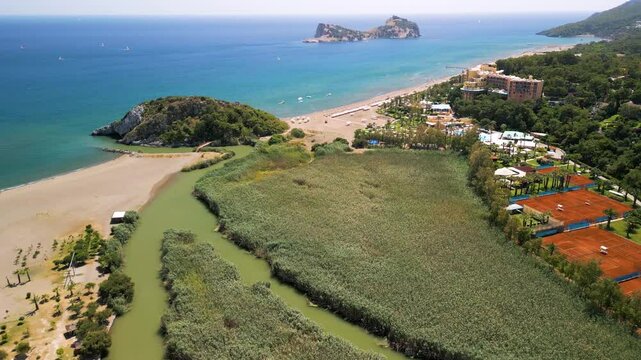 Aerial view of beach, river, sea, buildings, and island in Ortaca, Turkey.