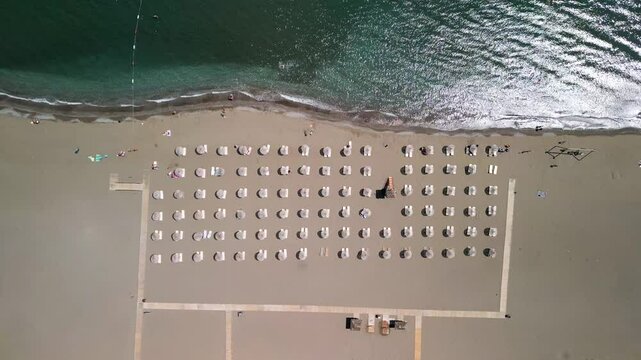 Aerial view of tranquil beach with umbrellas and chairs, Turkey.
