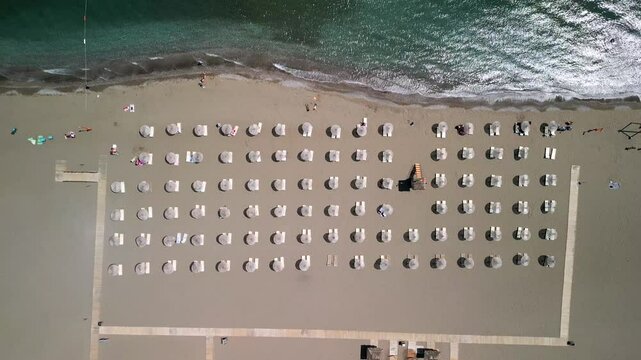 Aerial view of tranquil beach with umbrellas and chairs, Mugla, Turkey.