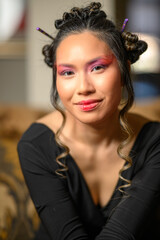 Creative Asian Beauty Portrait of Woman with Artistic Makeup and Hair Buns