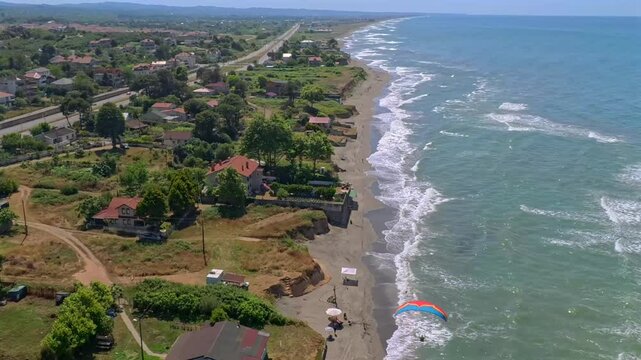 Aerial view of beach and homes with greenery, Turkey.