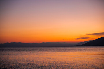 Beautiful sunset with clouds over the lake.