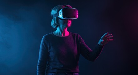 Woman wearing a virtual reality headset with hand outstretched in a dark room.