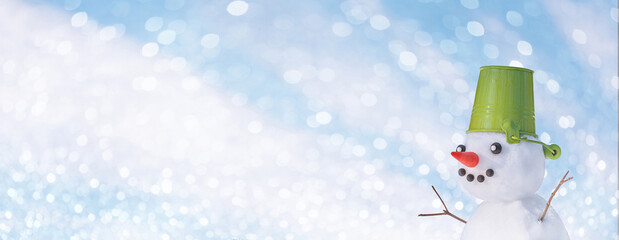 Christmas winter banner with snowman with a pail on his head in winter forest. Holiday background...