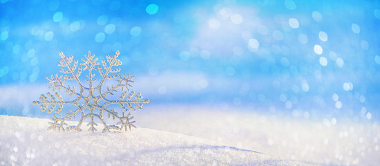 Christmas winter background, banner - view of decorative snowflake in sparkling snow, copy space for text