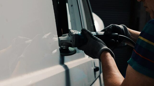 Auto Body Repair Technician Working on Van Windows Frame at Workshop