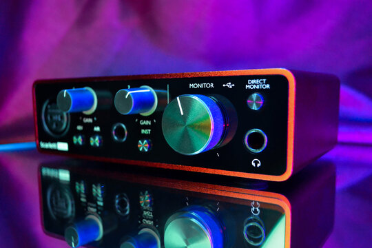 Focusrite Scarlett Solo audio interface illuminated with neon lights
Editorial use only. Scarlett Solo USB audio interface by Focusrite, photographed with colorful neon lighting and reflection on a gl