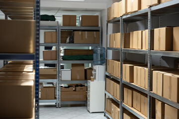 Spacious empty warehouse interior with shelving units and storage racks ready for goods, packages...