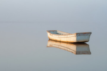 minimalist scene of solitary vessel on tranquil waters in coastal wetlands of sierra leone