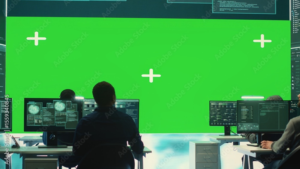 Poster team of governmental hackers look at green screen in high tech agency office, working together on ha