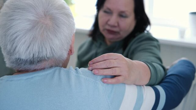 Senior couple hugging each other, kissing at home bedroom. Intimate Moment. Tender embrace between elderly age man and woman, husband and wife. Old people deep love. Time and feelings. Loving family
