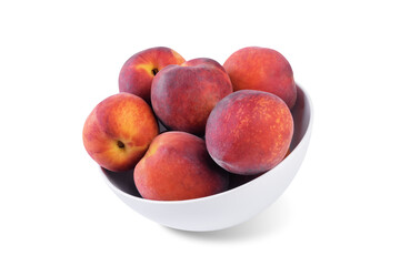 Fresh raw peaches in a white bowl on a white isolated background