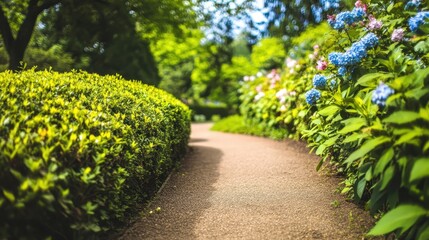 Obraz premium Peaceful Garden Path Surrounded by Lush Greenery and Flowers