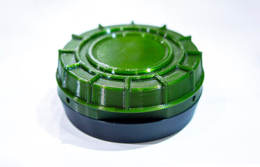 Anti-personnel high explosive mine printed on 3D printer isolated on white background.. Mine created on 3D printer from molten plastic. Prototype of ammunition printed on 3D printer. Innovation modern