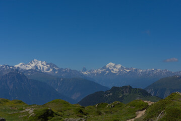 The majestic, snow-capped Matterhorn stands prominently against a clear blue sky, embodying awe-inspiring natural beauty and alpine grandeur. Perfect for showcasing iconic landscapes.
