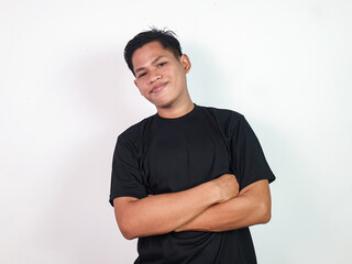 A confident Asian man stands against a plain white background, crossing his arms confidently. Ideal...
