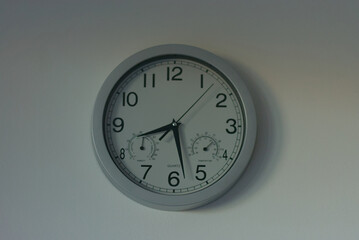 A sleek, modern wall clock with integrated temperature and humidity gauges, perfect for tracking...