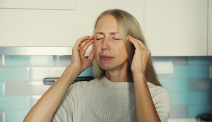 Exhausted tired woman suffering from headache, stress, fatigue, temples pain, migraine, loud noise